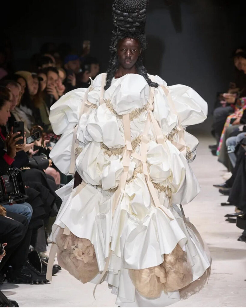 Modelo veste vestido branco de coleção de outono-inverno da Comme des Garçons no PFW 2024